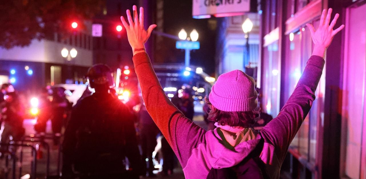 A demonstrator holds up hands in front of police during a protest the day after Election Day in Portland, Oregon. Credit: Reuters Photo