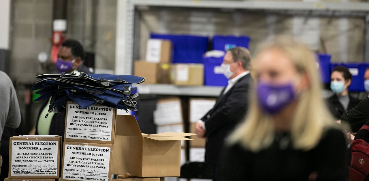 Members of an adjudication review panel look over scanned absentee ballots at the Fulton County Election Preparation Center on November 4, 2020 in Atlanta, Georgia. Credit: AFP Photo