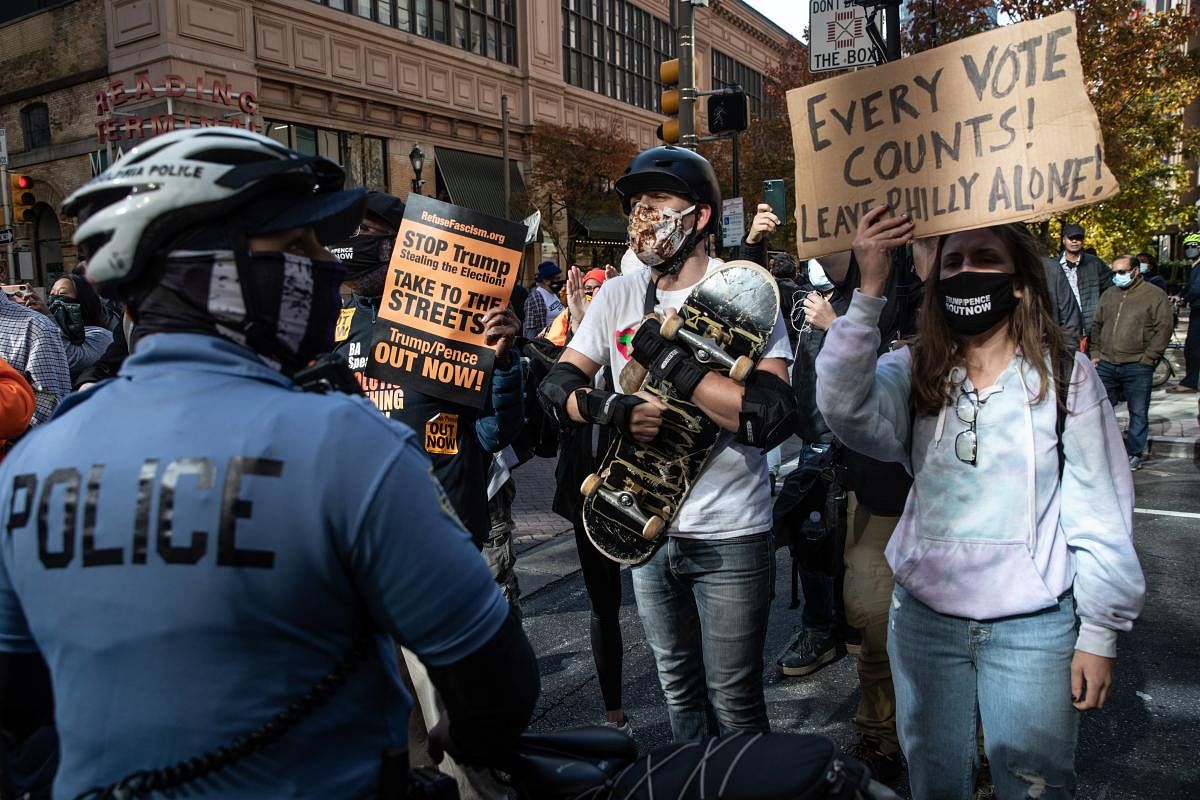  A police officer stands in front of people participating in a protest in support of counting all votes as the presidential election in Pennsylvania is still too close to call on November 5, 2020 in Philadelphia, Pennsylvania. With no winner yet declared in the presidential election, attention is focused on the outcome of a few remaining swing states. Credit: Getty Images/AFP