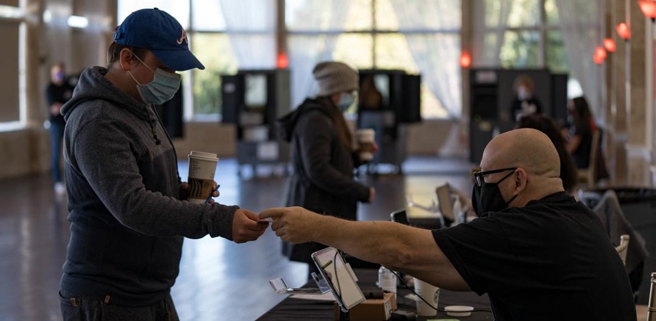 After a record-breaking early voting turnout, Americans headed to the polls on the last day to cast their vote. Credit: AFP