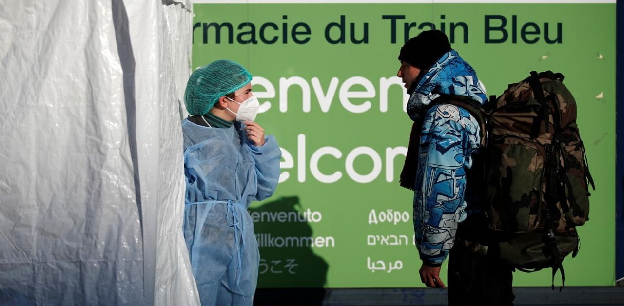 A medical staff member emerges from a Covid-19 mobile tent testing area in front of a pharmacy near Gare de Lyon train station in Paris. Credit: Reuters