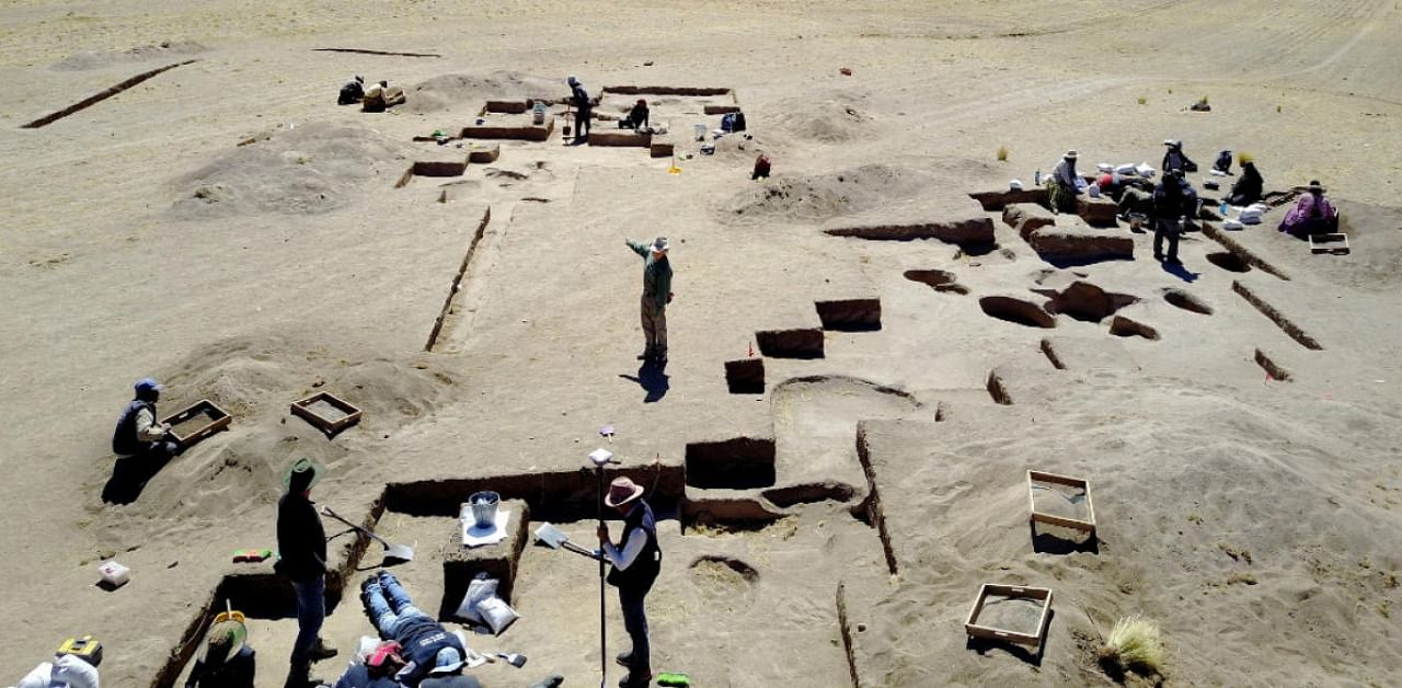 In this undated photo provided BY UC Davis to AFP on November 4, 2020, Archeologists conduct excavations at Wilamaya Patjxa in Peru. Credit: AFP PHOTO /UC Davis/ Randall Haas.