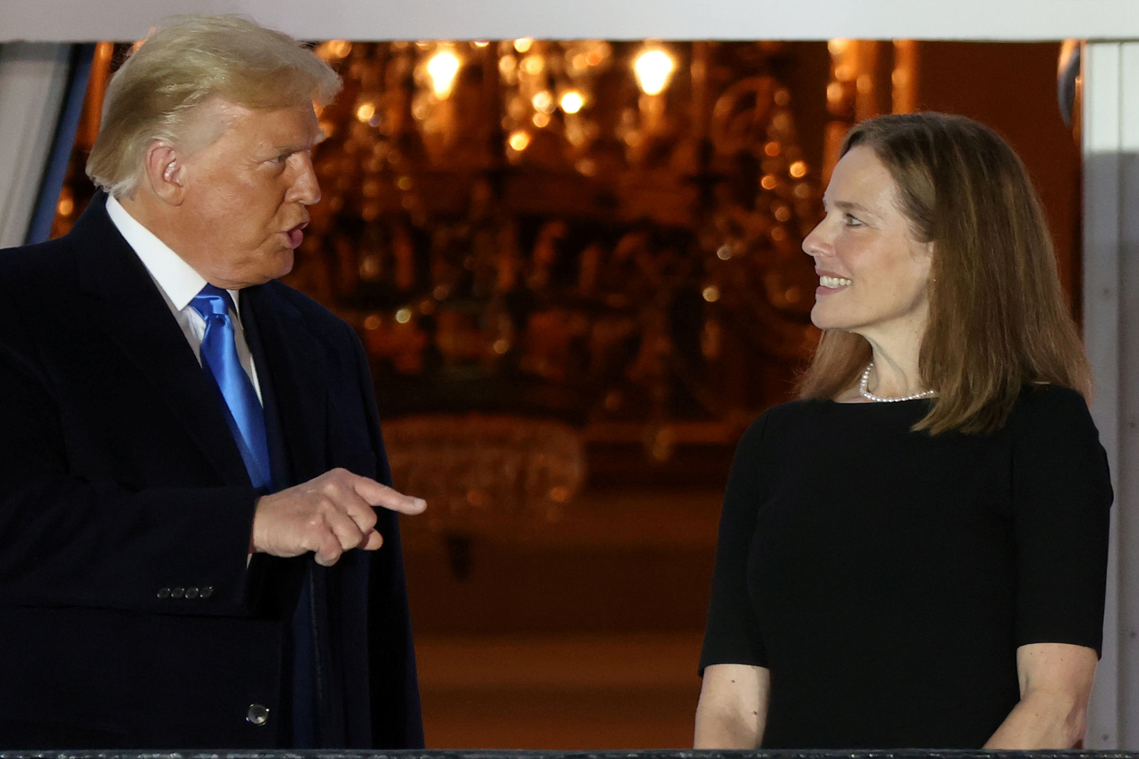 US President Donald Trump speaks with Judge Amy Coney Barrett after she was sworn in as an associate justice of the U.S. Supreme Court on the South Lawn of the White House in Washington, US October 26, 2020. Credit: REUTERS