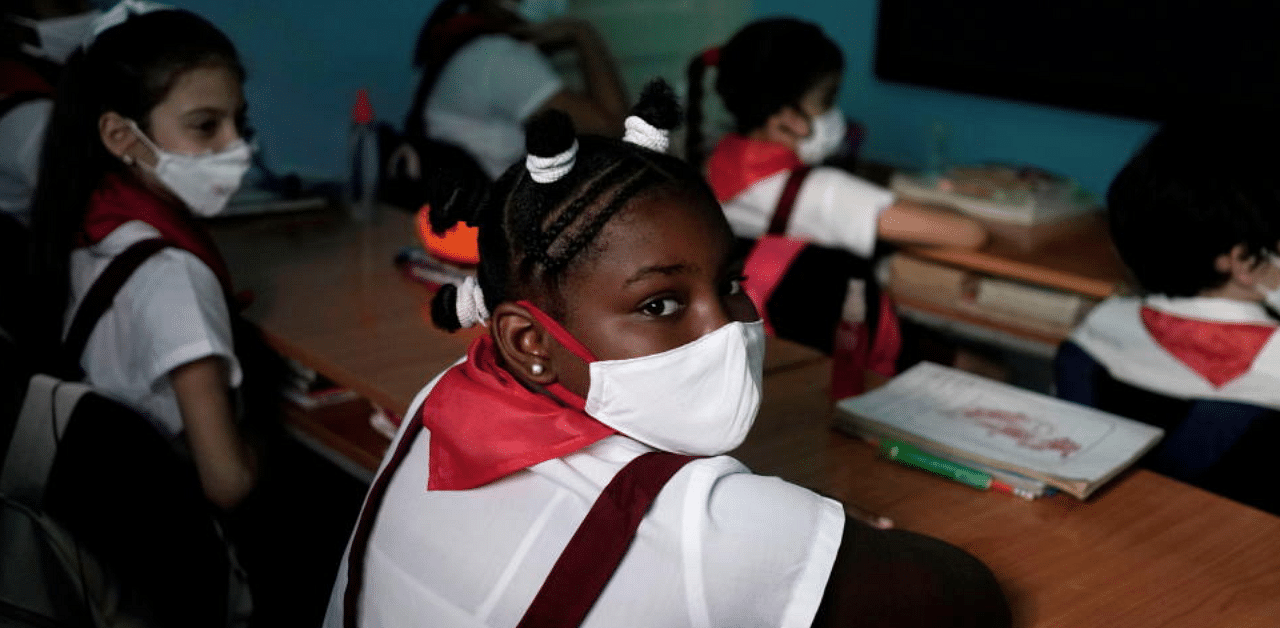 Children watch a lesson during their first day of classes since April amid COVID-19 concerns in Havana, Cuba, November 2, 2020. Credit: Reuters Photo