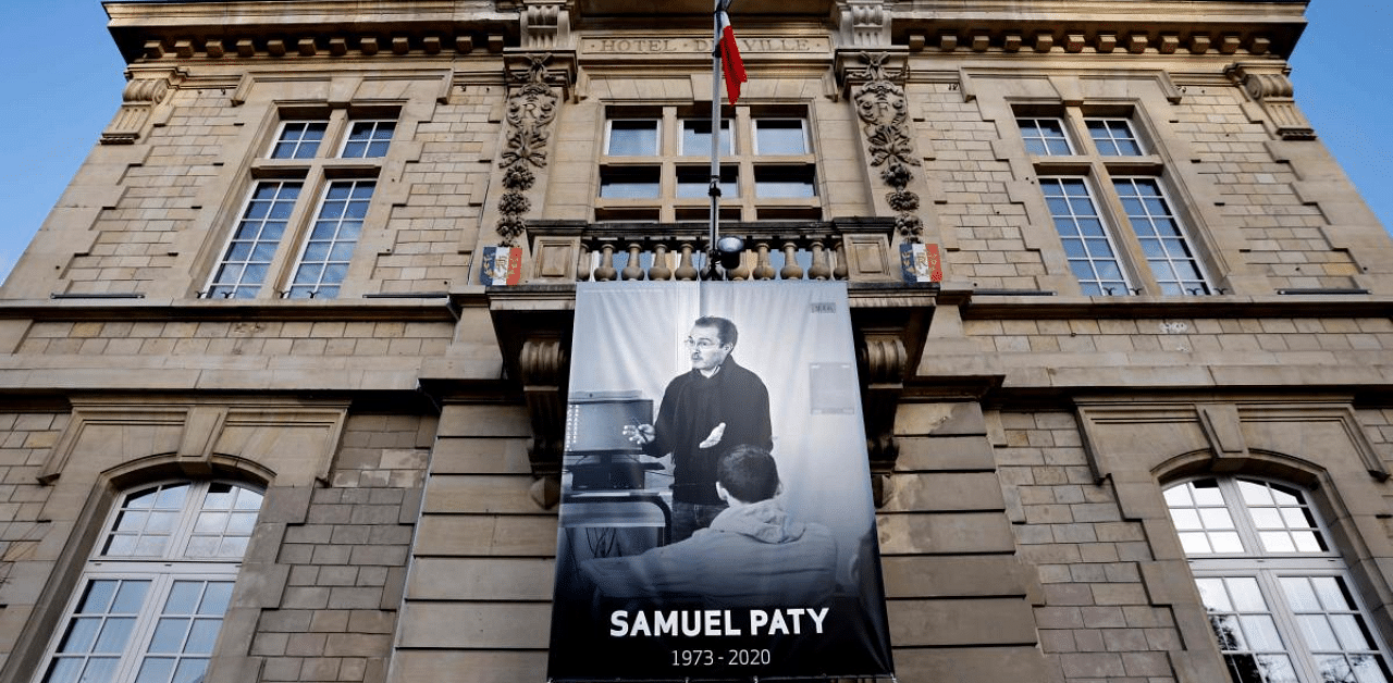 French teacher Samuel Paty placed on the facade of the city hall in Conflans-Sainte-Honorine, 30kms northwest of Paris, following the decapitation of the teacher on October 16. Credit: AFP Photo