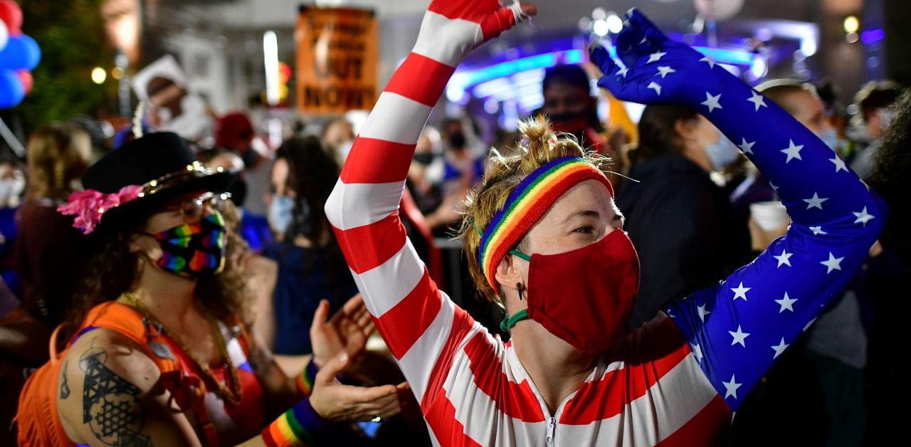 People cheer after Democratic presidential nominee Joe Biden overtook President Donald Trump in the Pennsylvania general election vote count. Credit: Reuters Photo