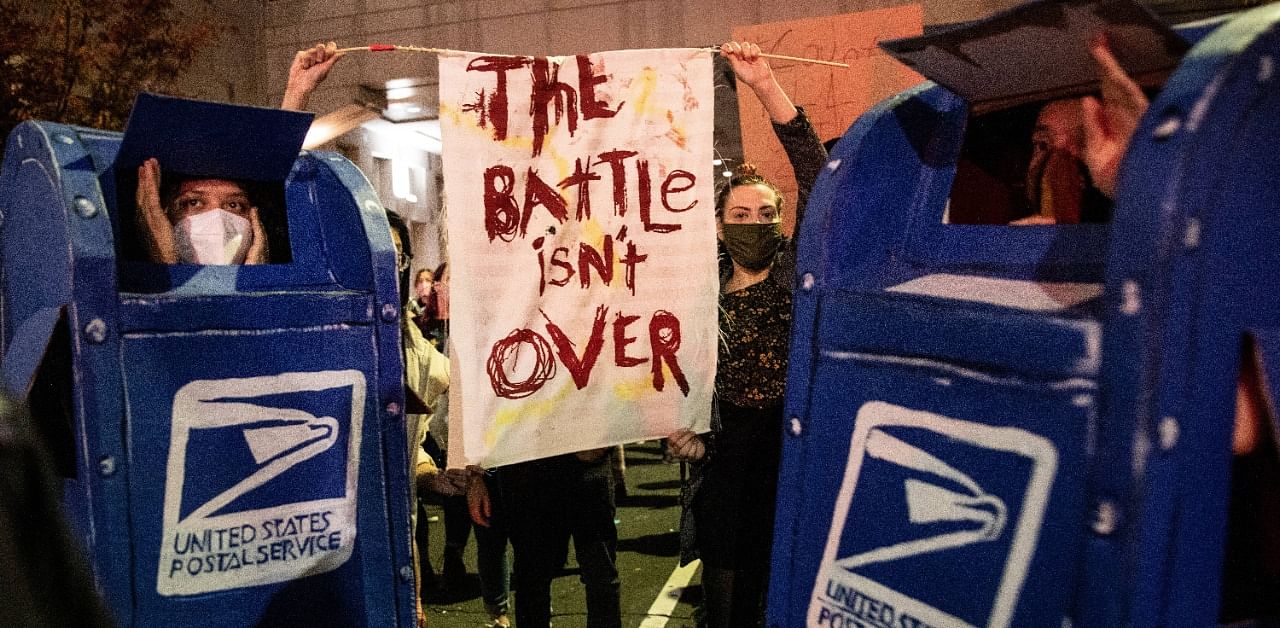 People participate in a protest in support of counting all votes, hold signs and chant slogans at supporters of US President Donald Trump outside of the Philadelphia Convention Center. Credit: AFP Photo