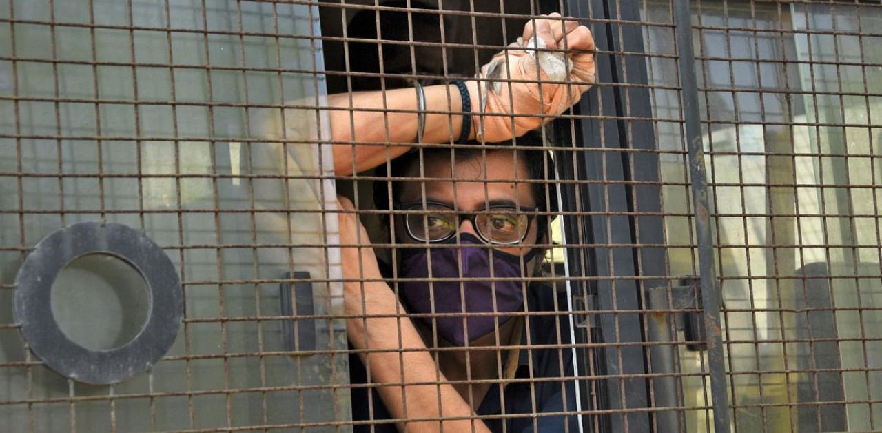 Arnab Goswami sits inside a police van outside a court after he was arrested at Alibaug town in Maharashtra. Credit: Reuters Photo