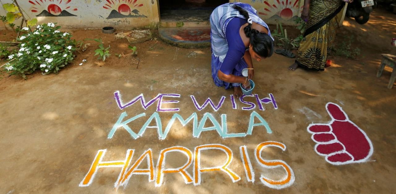 Woman applies finishing touches to a message for US Democratic vice presidential nominee Kamala Harris in Painganadu near the village of Thulasendrapuram, where Harris' maternal grandfather was born and grew up, in Tamil Nadu state. Credit: Reuters