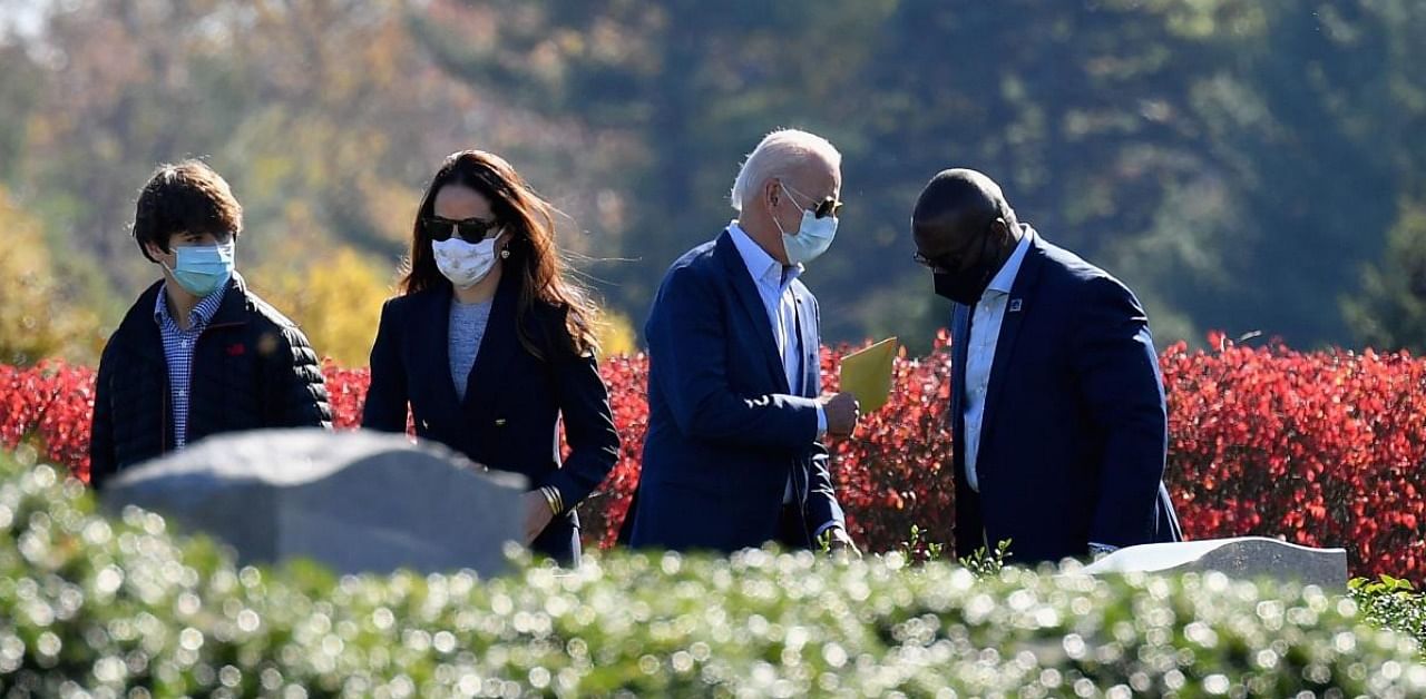 Joe Biden (2ndR) and his daughter Ashley Biden (C) leave after visiting their family grave at St. Joseph on the Brandywine Roman Catholic Church in Wilmington. Credit: AFP.
