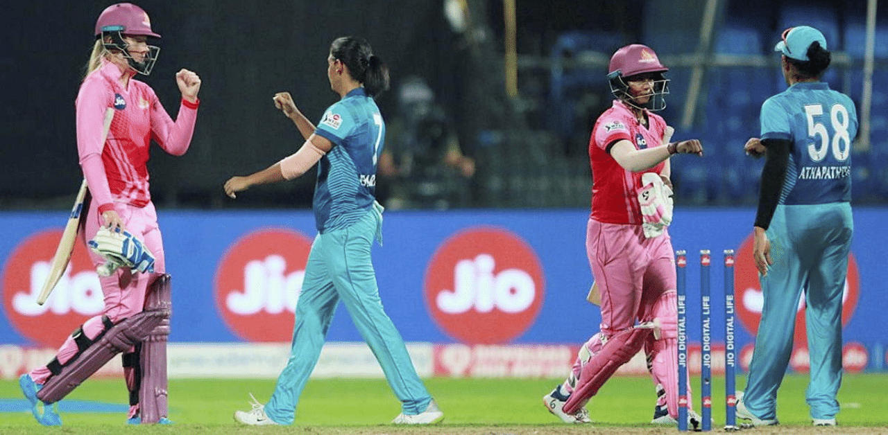 Harmanpreet Kaur (c) of the Supernovas exchanges greetings with the Trailblazers players after their match. Credit: PTI Photo