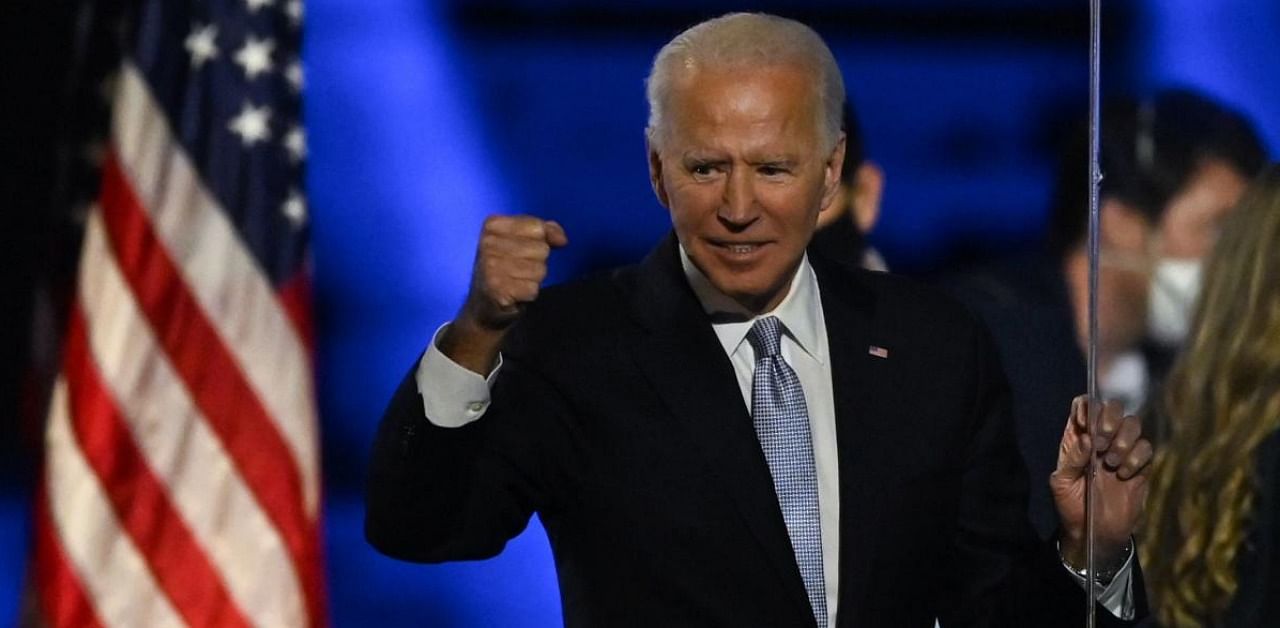 US President-elect Joe Biden holds up his fist after delivering remarks in Wilmington, Delaware, on November 7, 2020, after being declared the winners of the presidential election. Credit: AFP.