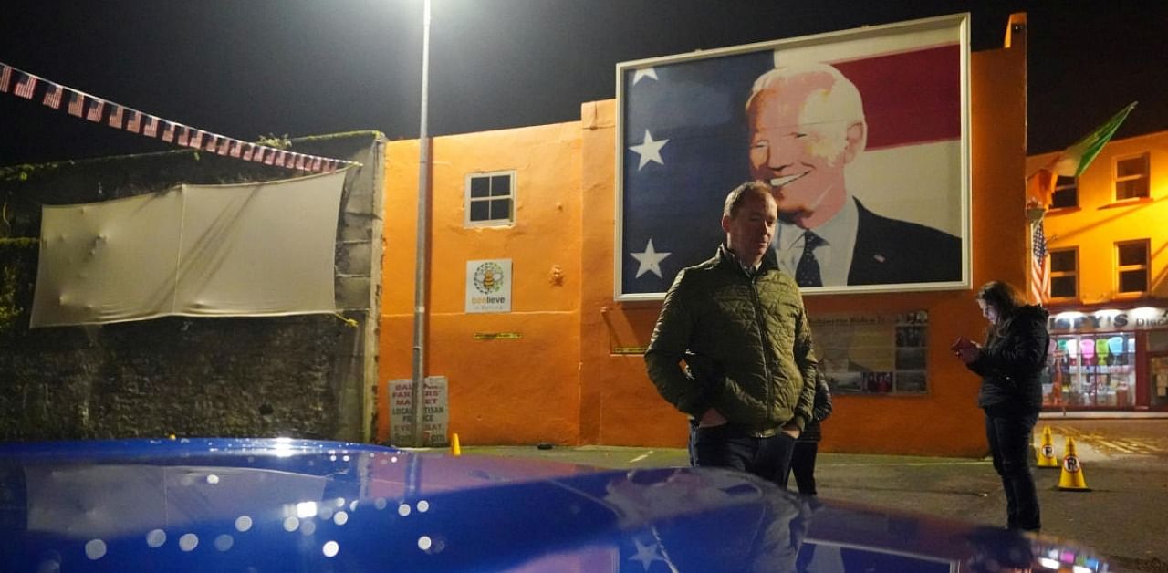 Plumber Joe Blewitt, who is a cousin of US Democratic presidential candidate Joe Biden, stands at a support rally for him as votes continue to be counted three days after the US election, in Biden's ancestral home of Ballina. Credit: Reuters.