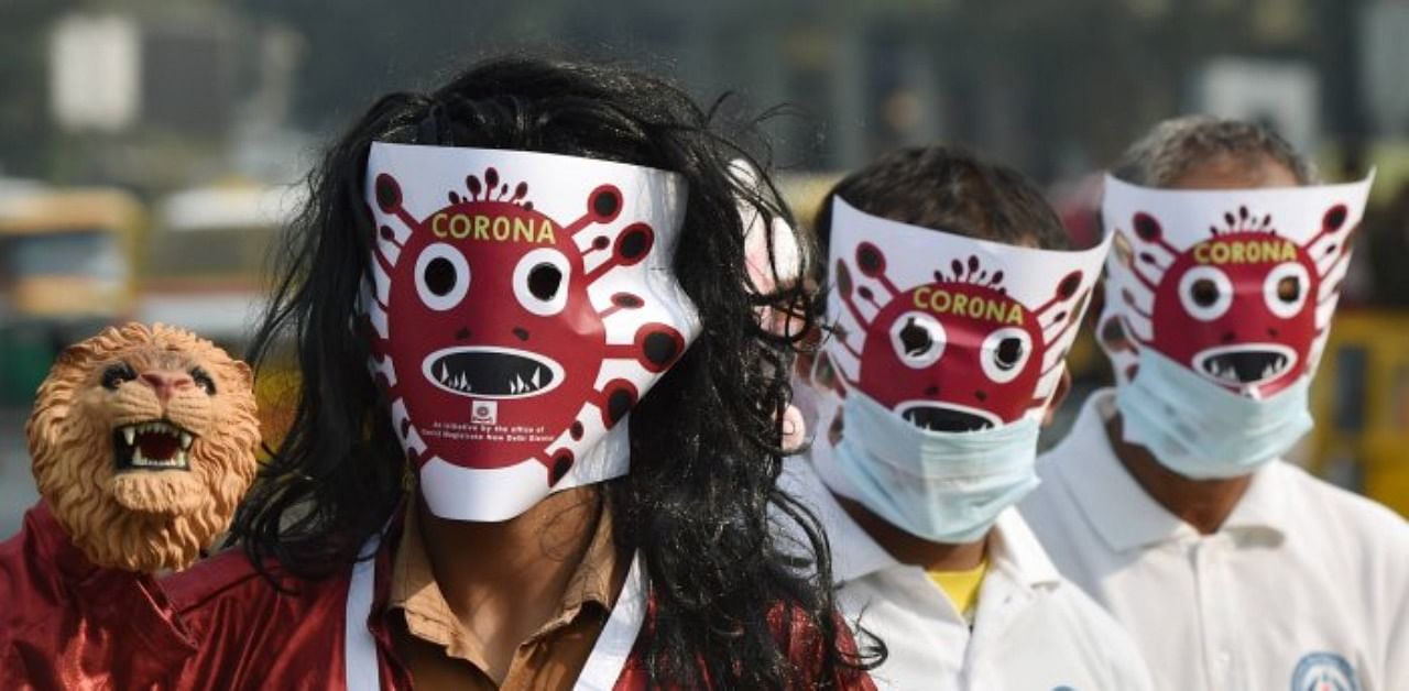 Volunteers, wearing masks, participate in a Covid-19 awareness procession as coronavirus cases rise across the national capital, at Connaught Place in New Delhi. Credit: PTI Photo