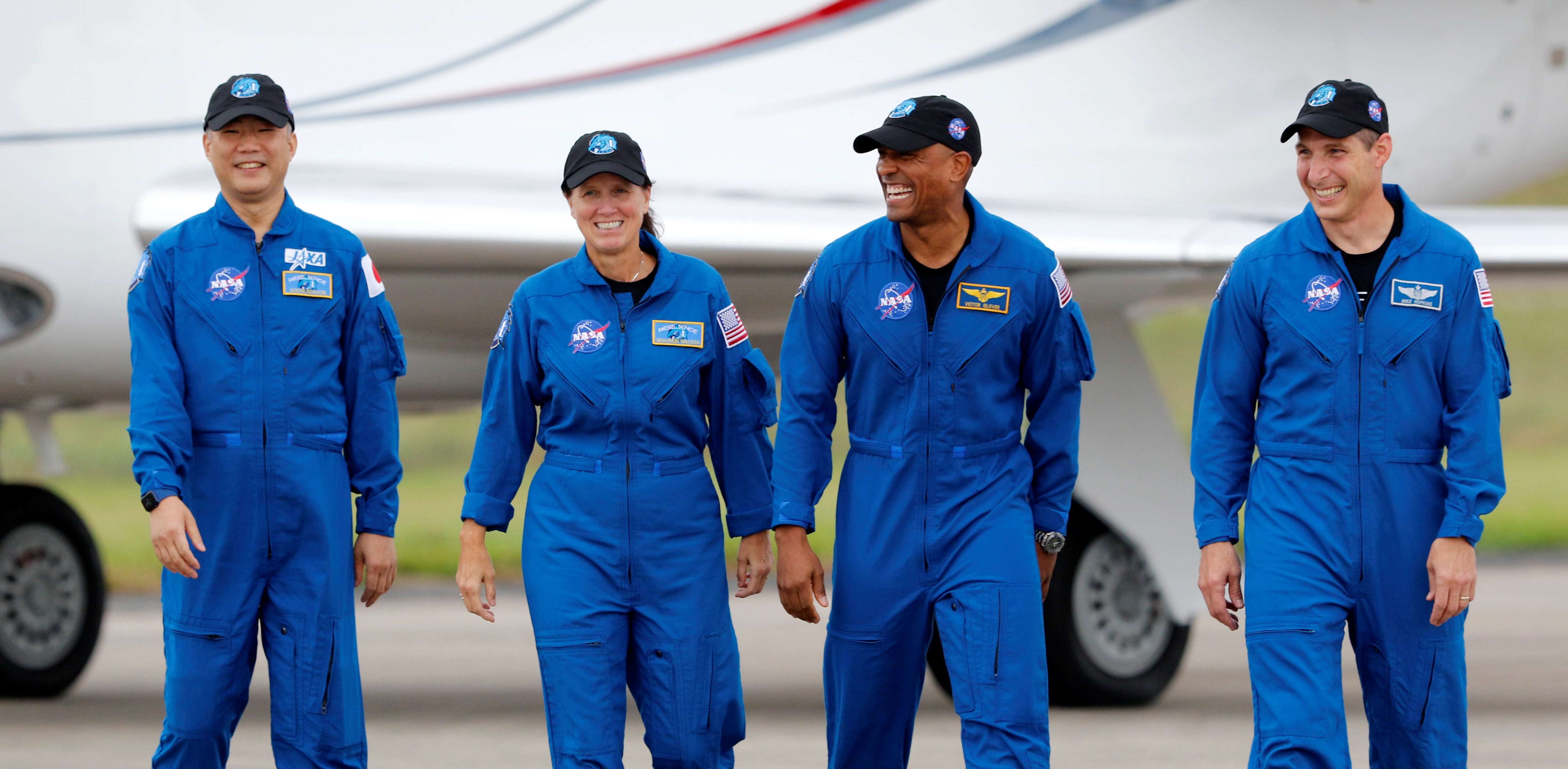 NASA astronauts Shannon Walker, Victor Glover, Mike Hopkins, and JAXA (Japan Aerospace Exploration Agency) astronaut Soichi Noguchi, who comprise Crew-1, walk at Kennedy Space Center ahead of the NASA/SpaceX launch of the first operational commercial crew mission in Cape Canaveral, Florida. Credit: Reuters