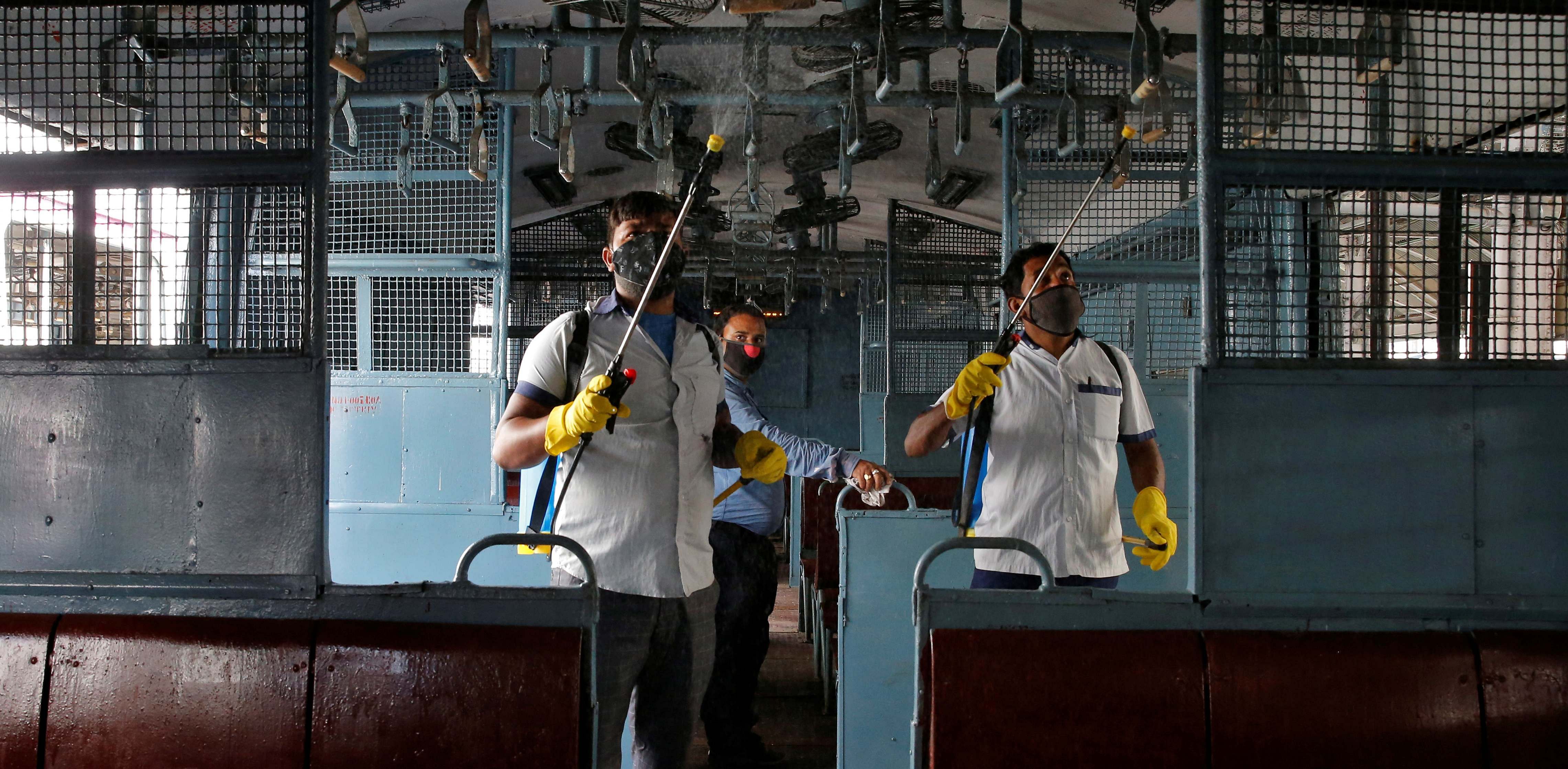 Workers spray disinfectant to sanitize a suburban train coach before authorities resume the train services, amidst the coronavirus disease (COVID-19) outbreak, at Howrah station on the outskirts of Kolkata. Credit: Reuters