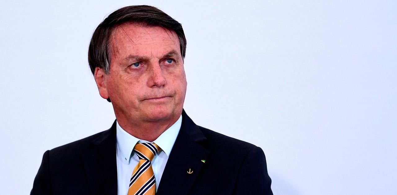 Brazilian President Jair Bolsonaro gestures during the launch of a program for the resumption of tourism, a sector severely affected by the new coronavirus outbreak, at Planalto Palace in Brasilia. Credit: AFP Photo