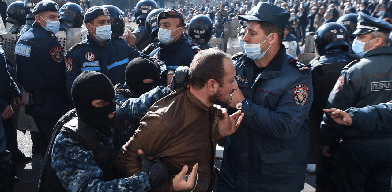 A man is taken away by law enforcement officers during an opposition rally to demand the resignation of Armenian Prime Minister Nikol Pashinyan 
