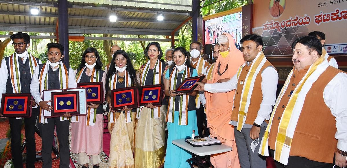 Minister for Health and Family Welfare and Medical Education Dr K Sudhakar presents certificates to the students during the 11th Convocation of JSS Academy of Higher Education and Research (JSSAHER) at Suttur Mutt near Chamundi foothill in Mysuru on Wedne