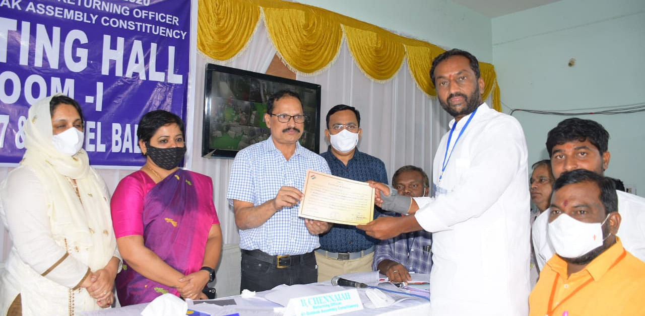 Raghunandan Rao receiving his election certificate from the ECI officials on Tuesday. Credit: Special arrangement