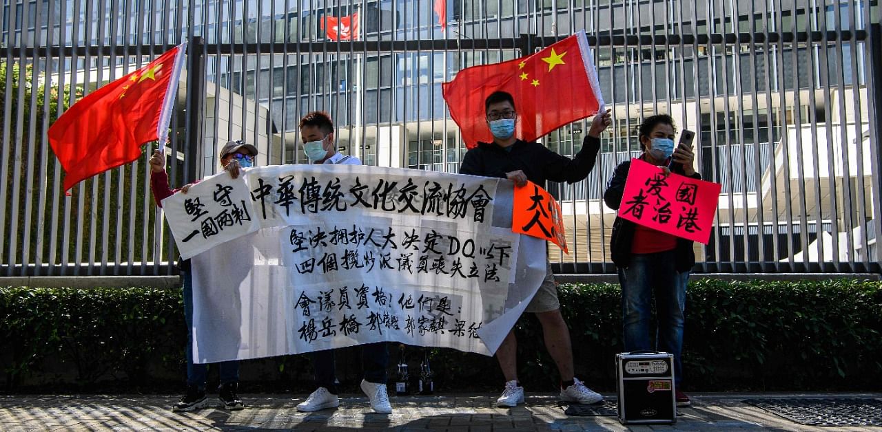 Pro-Beijing supporters gather outside the Legislative Council in Hong Kong on November 12, 2020, a day after the city's pro-Beijing authorities ousted four pro-democracy lawmakers. Credit: AFP Photo