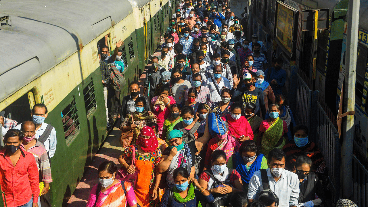 Commuters arrive at a suburban railway station after train service resumed following its closure due to the Covid-19 coronavirus pandemic in Kolkata. Credits: AFP Photo