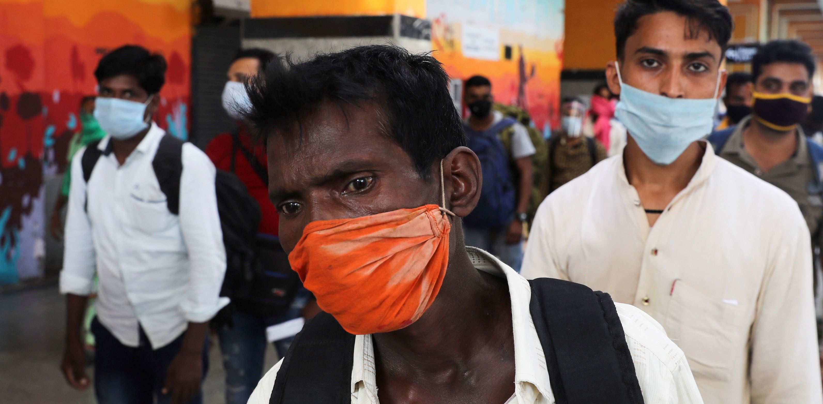Passengers wearing protective face masks stand in a queue on a platform to get tested for the coronavirus disease (COVID-19), at a railway station, in New Delhi. Credit: Reuters