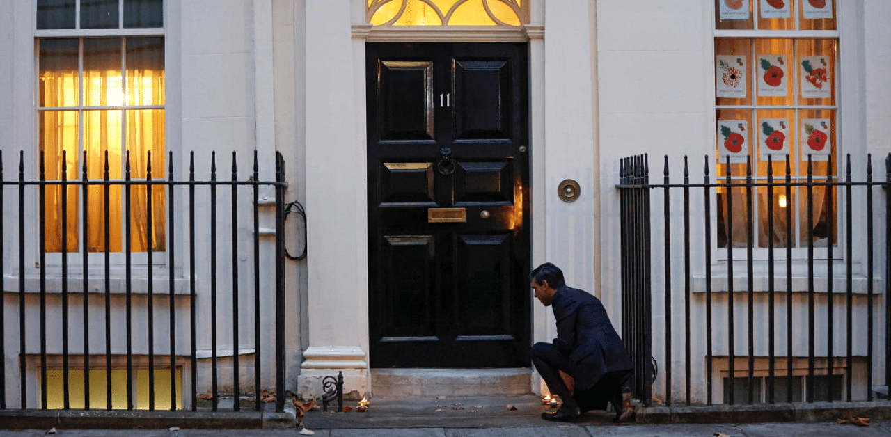 Britain's Chancellor of the Exchequer Rishi Sunak lights candles outside Downing Street ahead of the Hindu festival of Diwali, in London, Britain. Credit: Reuters Photo