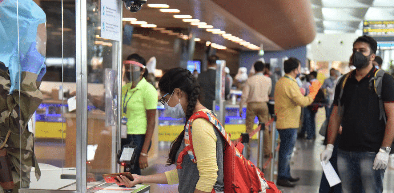 Passengers scanning boarding pass during the contactless walkthrough of the terminal at the Kempegowda International Airport in Bengaluru. Credit: DH Photo