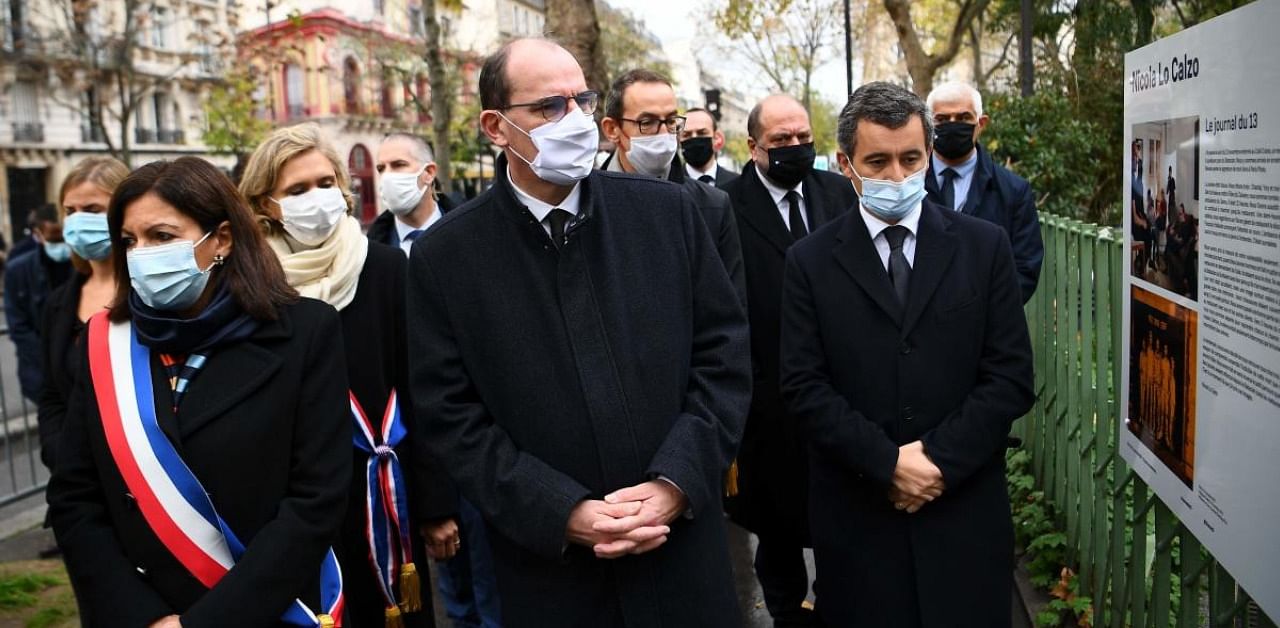 Paris Mayor Anne Hidalgo (L), French Prime Minister Jean Castex (C), President of French Ile-de-France region Valerie Pecresse (2ndL) and French Interior Minister Gerald Darmanin (R) look at photographs by Italian photographer Nicola Lo Calzo. Credit: AFP