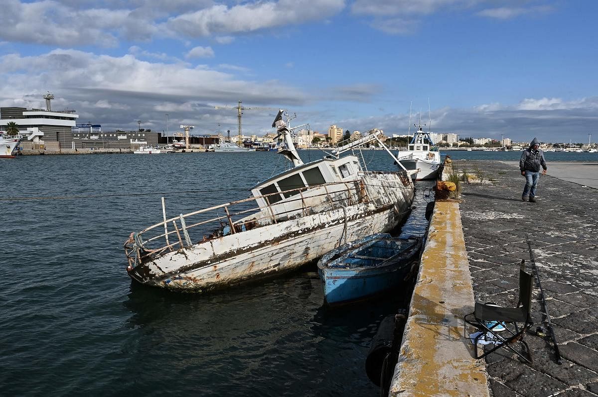 A picture taken on October 26, 2020 shows a fishing shipwreck in the new port, in Mazara del Vallo municipality of the province of Trapani in Sicily, less than 200 km from the Tunisian coast of North Africa. Credit: AFP