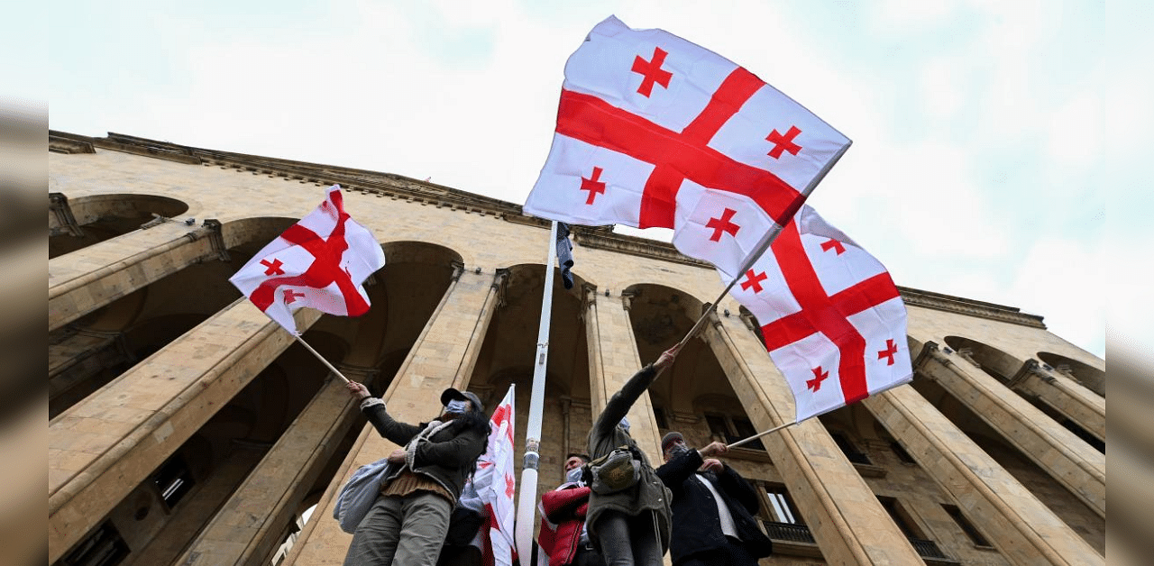Georgian opposition supporters wave the national flag during a rally in central Tbilisi on November 14, 2020. Credit: AFP Photo