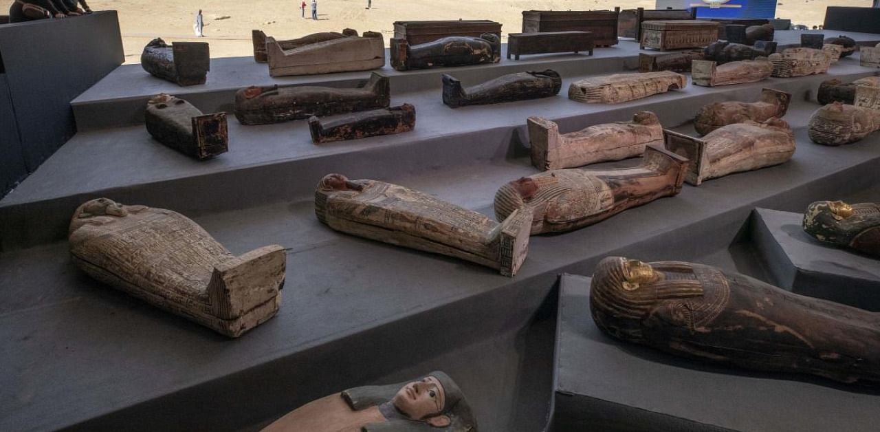 People look at ancient sarcophagi on display, discovered in a vast necropolis in Saqqara. Credit: AP/PTI.