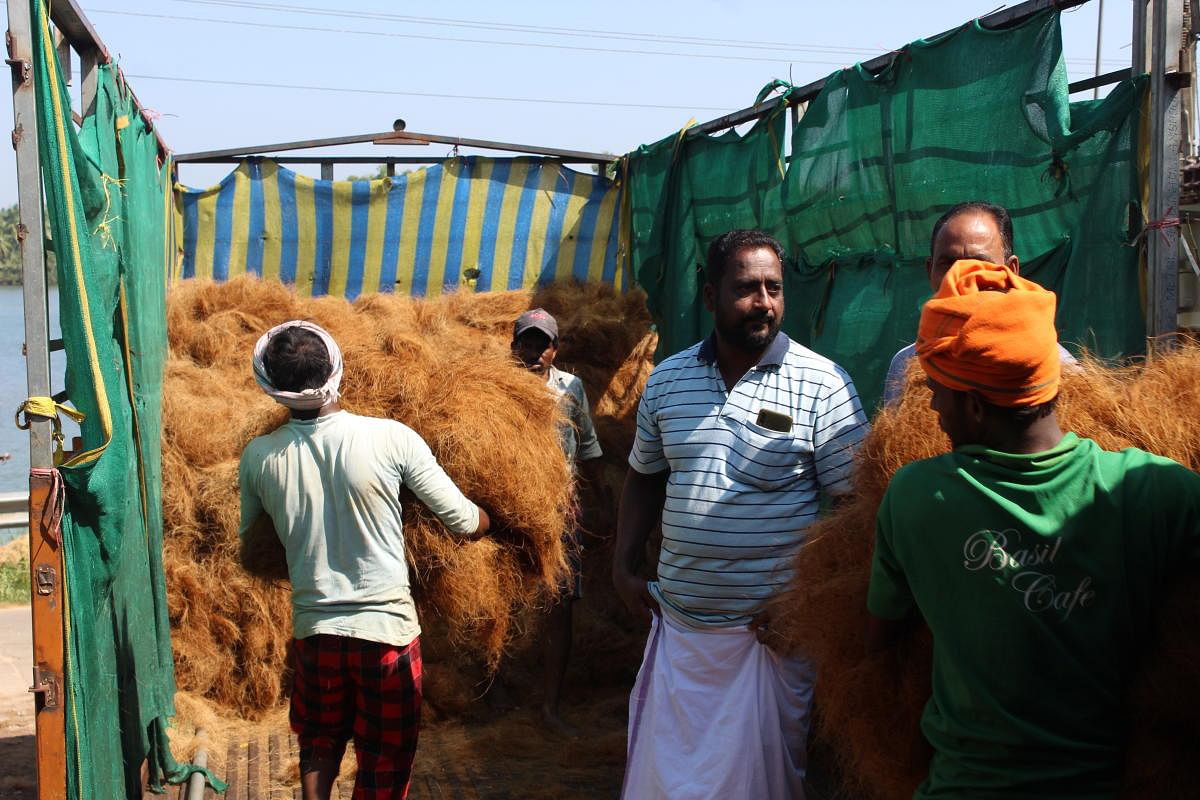 Satish Poojary supervises the coir being loaded into a truck.