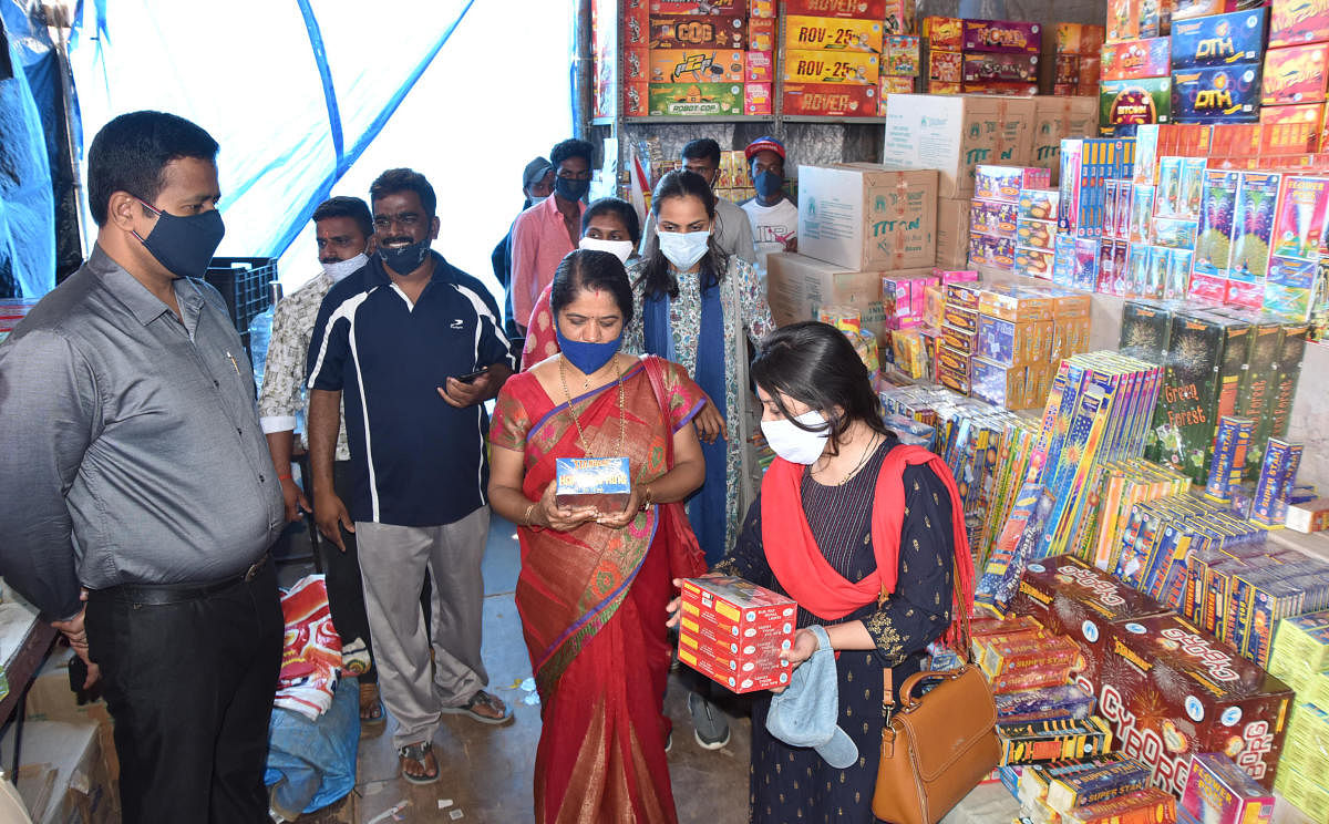 Deputy Commissioner of Police A N Prakash Gowda and other officials inspect crackers on JK Grounds in Mysuru on Saturday. DH PHOTO