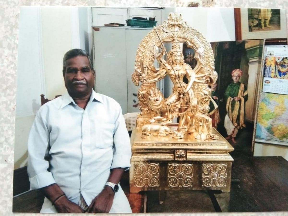 Sculptor N S Janardhana Murthy with the idol of Sri Chamundeshwari at Mysuru Palace.