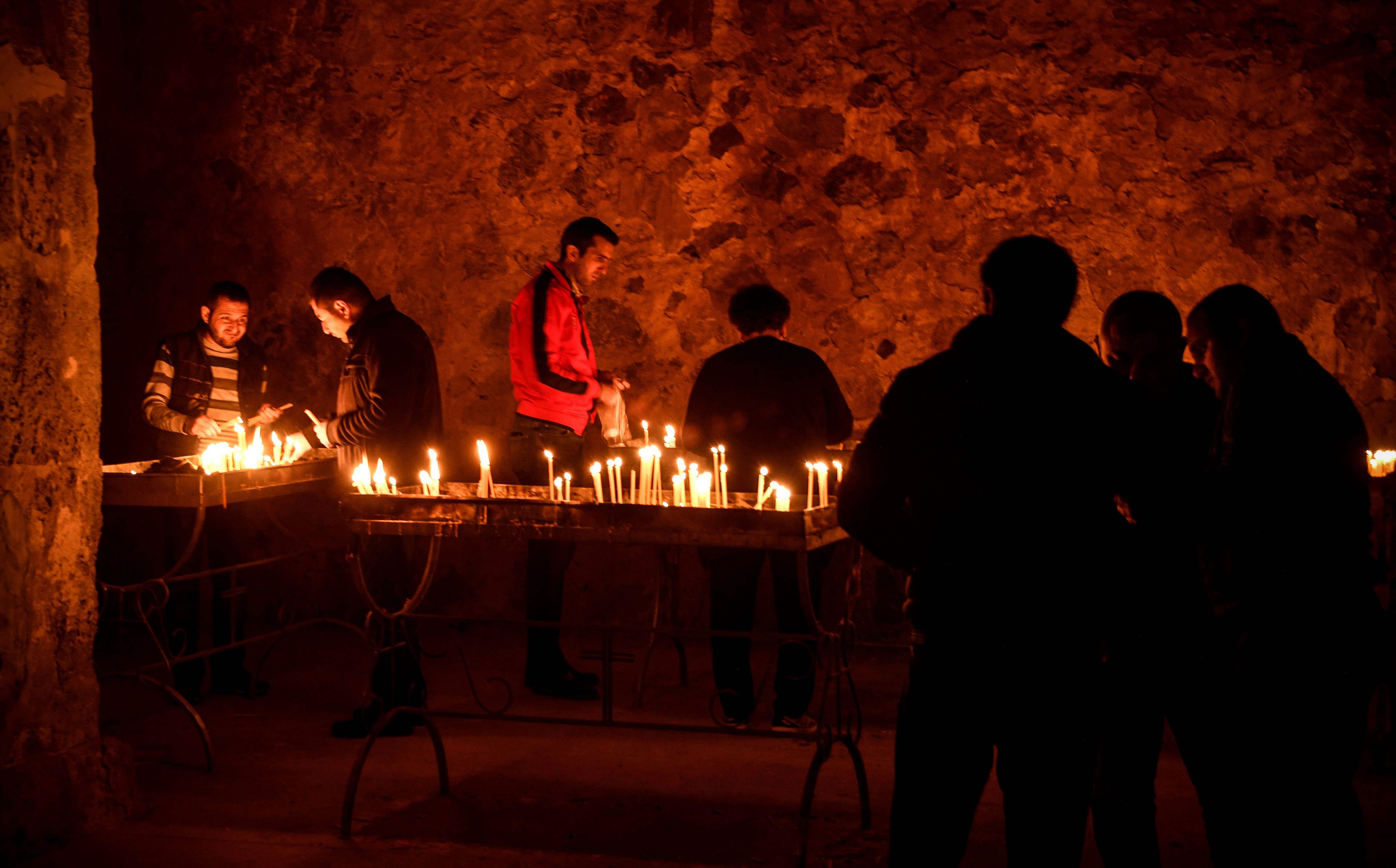 Armenian soldiers light candles as they pay a final tribute to comrades fallen during the military conflict between Armenia and Azerbaijan over the breakaway region of Nagorno-Karabakhat the Orthodox Dadivank Monastery on the outskirts of Kalbajar. Credits: AFP Photo