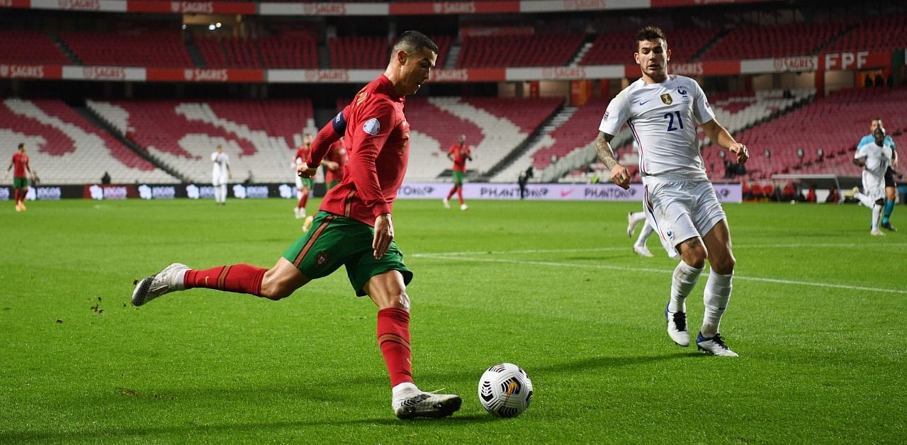 Portugal's forward Cristiano Ronaldo vies with France's defender Lucas Hernandez (R) during the UEFA Nations League A group 3 football match between Portugal and France at the Luz stadium in Lisbon. Credit: AFP Photo