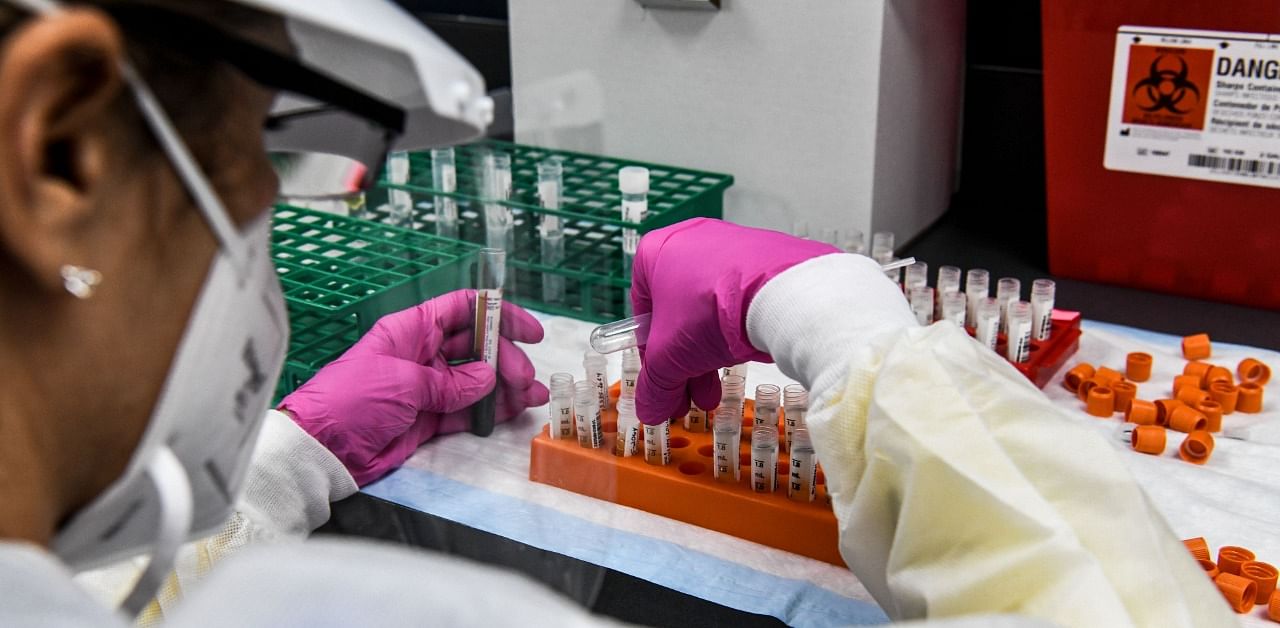 A lab technician sorts blood samples inside a lab for a Covid-19 vaccine study at the Research Centers of America (RCA) in Hollywood, Florida. Credit: AFP Photo