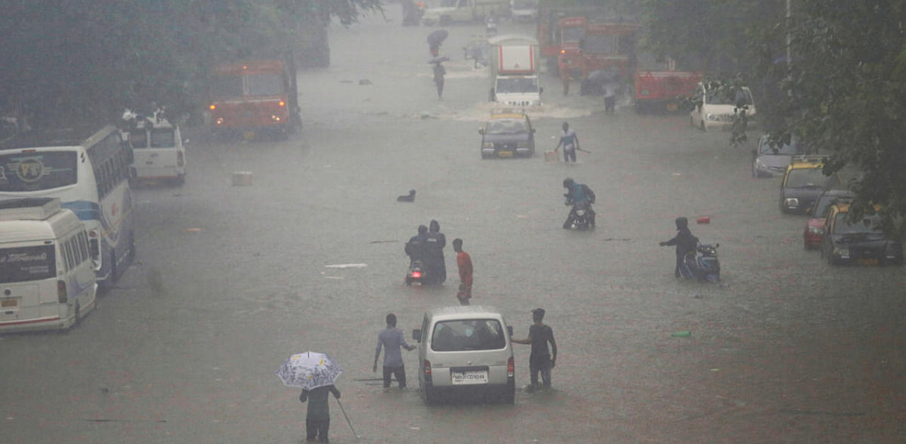 Commuters walk on a flooded street after a heavy rainfall in Mumbai, India, September 4, 2019. Credit: REUTERS