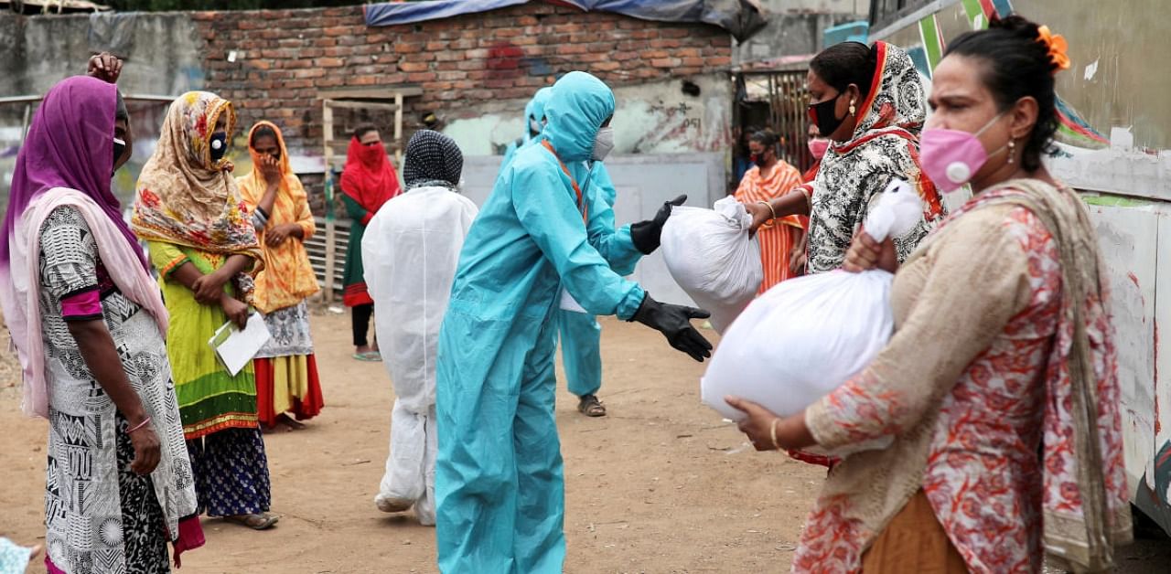 Volunteers from an organisation distribute relief supplies among transgenders, amid the coronavirus disease in Dhaka. Credit: Reuters