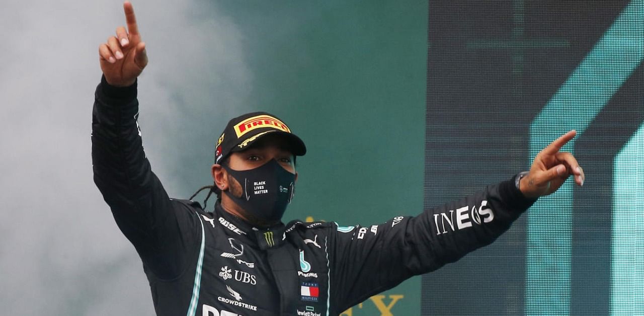 Mercedes' Lewis Hamilton celebrates on the podium after winning the race and the world championship. Credit: Reuters