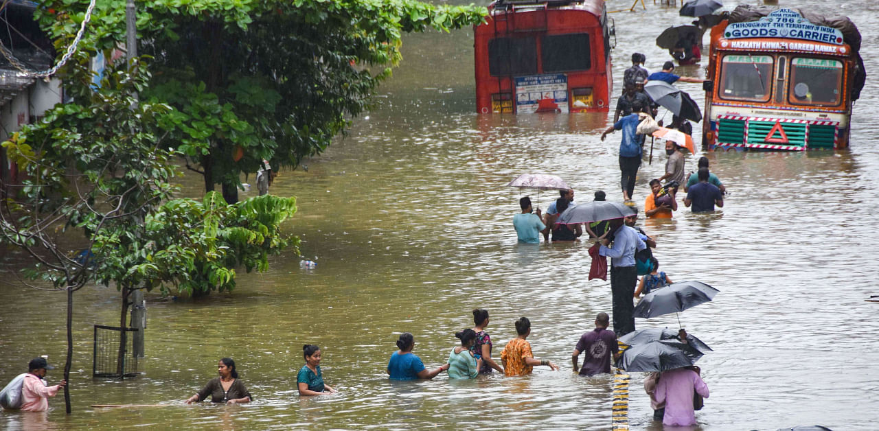People wade through a waterlogged street at Parel area, after heavy monsoon rain, in Mumbai, Wednesday, Sept. 23, 2020. Credit: PTI Photo