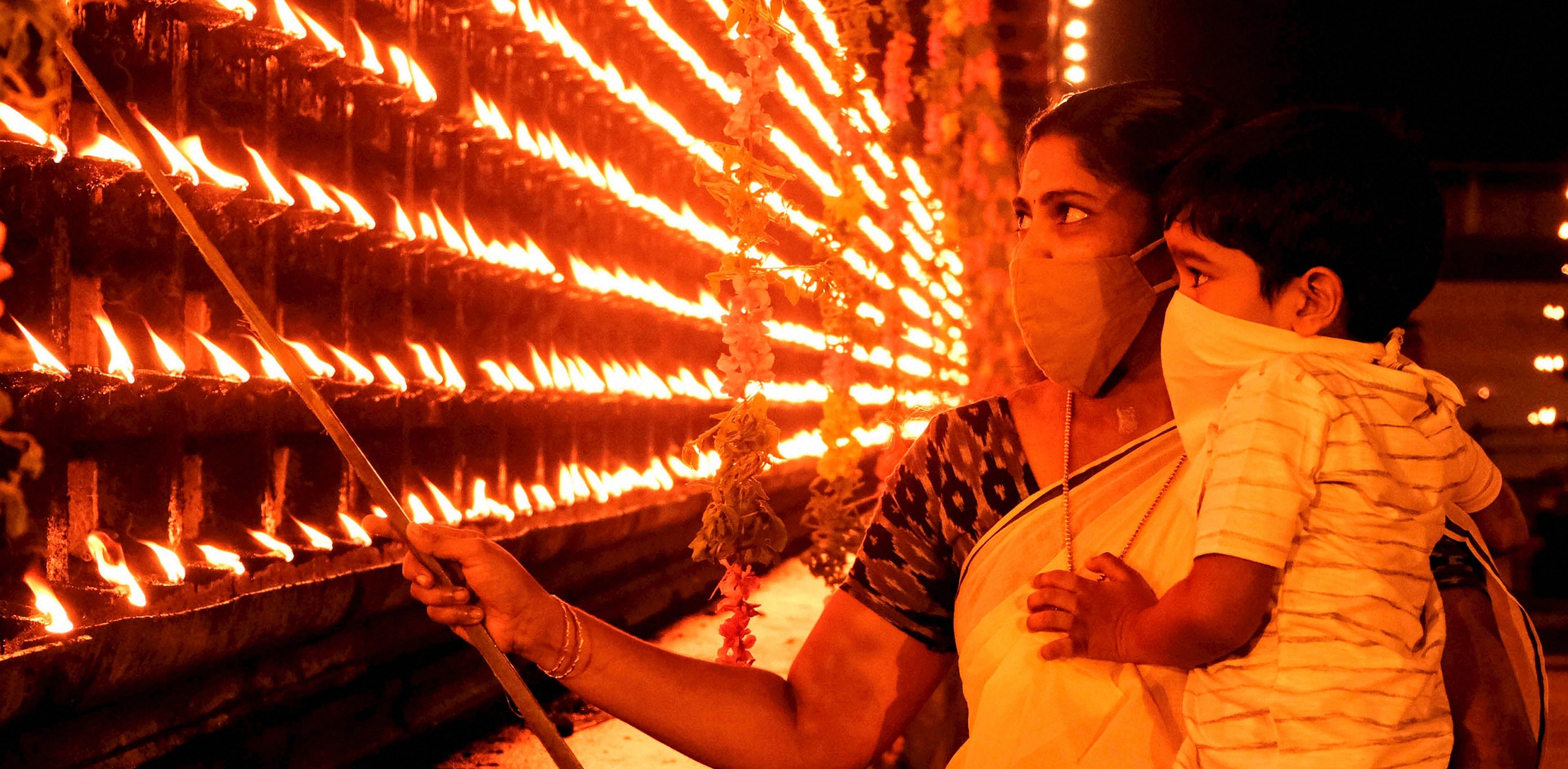 People light earthen lamp (Diyas) on the occasion of 'Diwali', in Thrippunithur, Credit: PTI