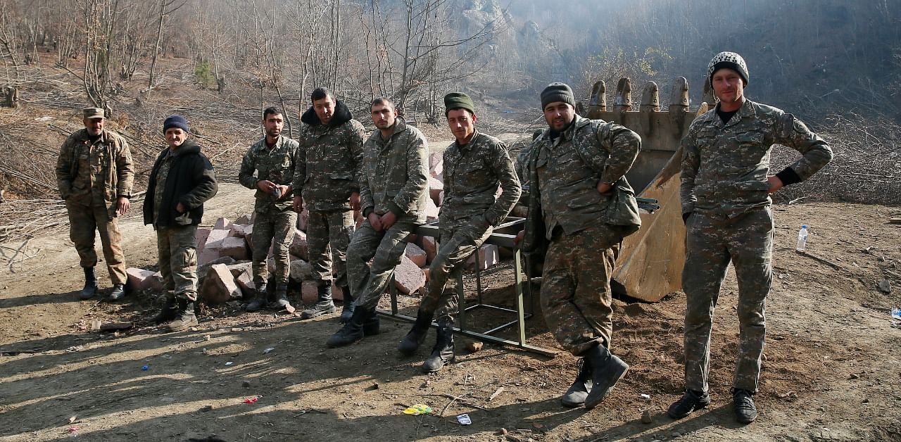 Ethnic Armenian soldiers are seen in the village of Knaravan located in a territory which is soon to be turned over to Azerbaijan under a peace deal that followed the fighting over the Nagorno-Karabakh region. Credit: Reuters Photo