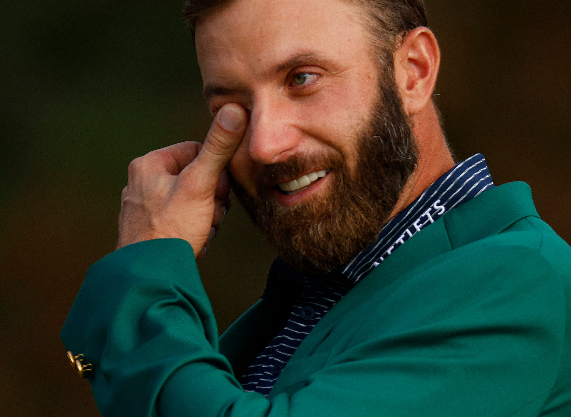 Dustin Johnson of the US celebrates with his green jacket after winning The Masters. Credit: REUTERS