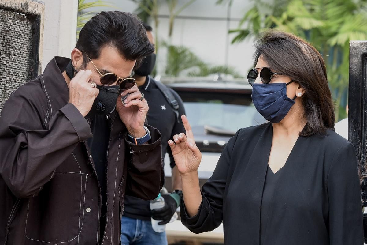 Bollywood actor Anil Kapoor (L) and actress Neetu Kapoor pose for photographs before leaving for the shoot of their upcoming Hindi film at Corporate Aviation Terminal in Mumbai. Credit: AFP file photo