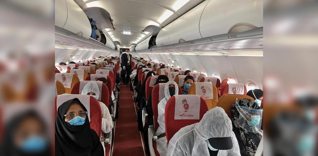 A handout picture provided by the Embassy of India in Riyadh on May 8, 2020 shows Indian expats inside a plane upon their departure at King Fahad International airport heading to Kozhikode. Credit: AFP 