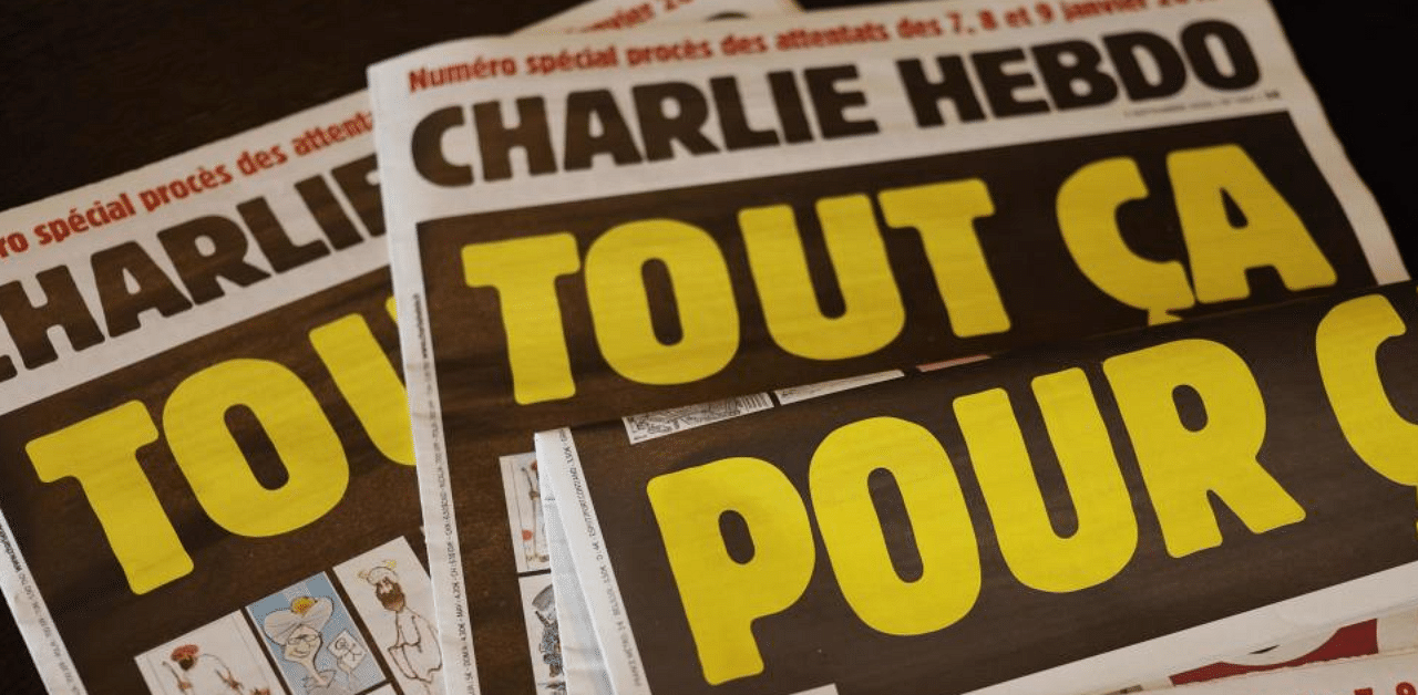 This picture taken on September 1, 2020 in Paris shows covers of French satirical weekly Charlie Hebdo reading "All of this, just for that," to be published on September 2 to mark this week's start of the trial for 14 accused in January 2015 jihadist attacks in Paris. Credit: AFP Photo