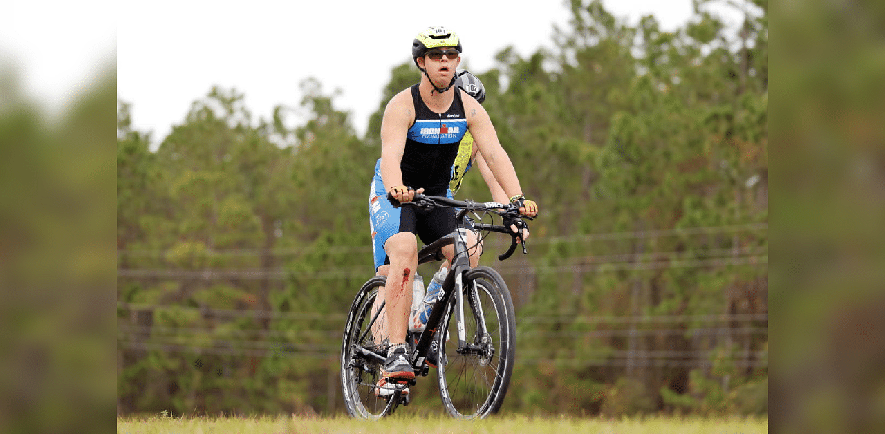 Chris Nikic competes in the bike portion with his guide, Dan Grieb during IRONMAN Florida in Panama City Beach, Florida, U.S. November 7, 2020.  Credit: Reuters Photo